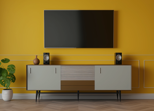 A home entertainment center with a large TV mounted to the wall